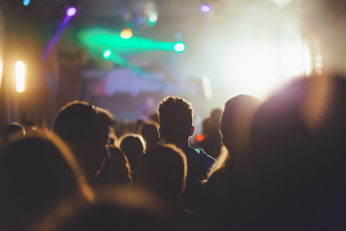 People dancing at concert and partying at festival